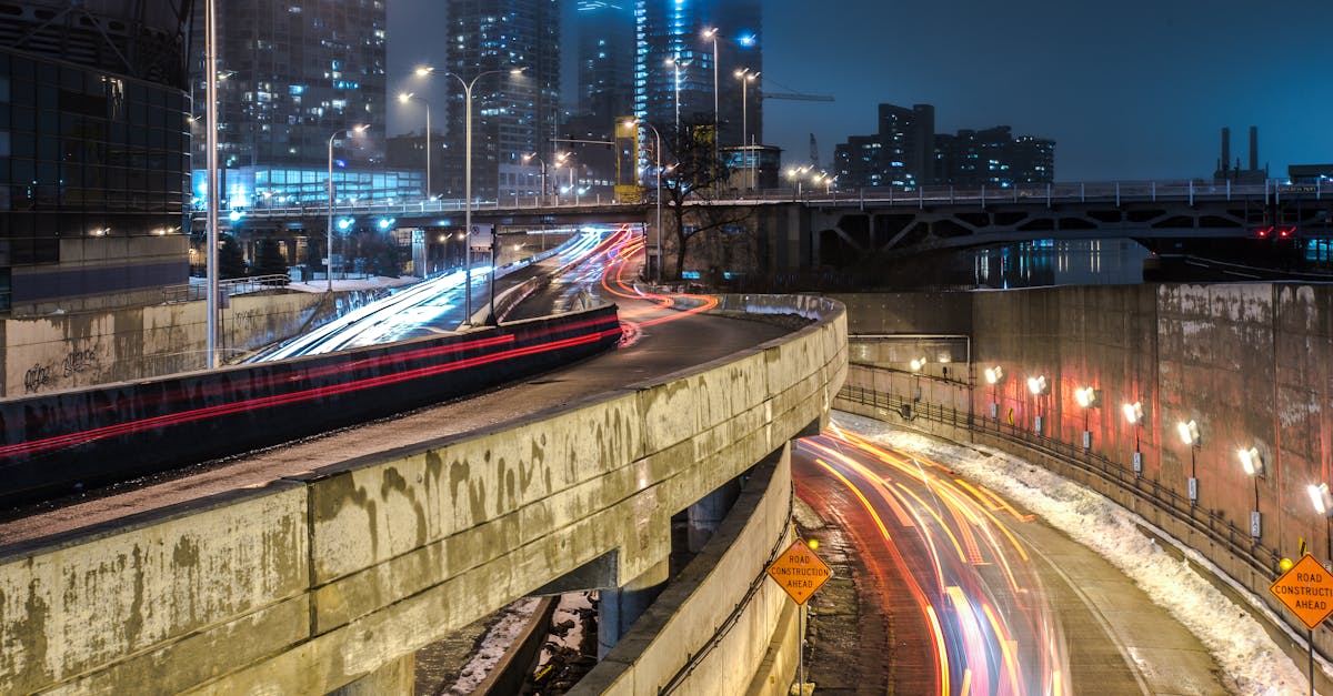 Vibrant night scene of Chicago city with light trails from moving cars on an urban highway.