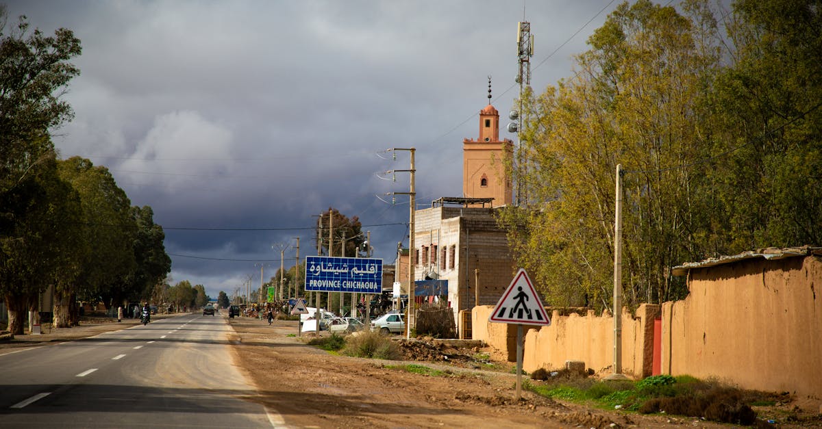 Street view of Chichaoua, Morocco with vibrant sky and traditional architecture.