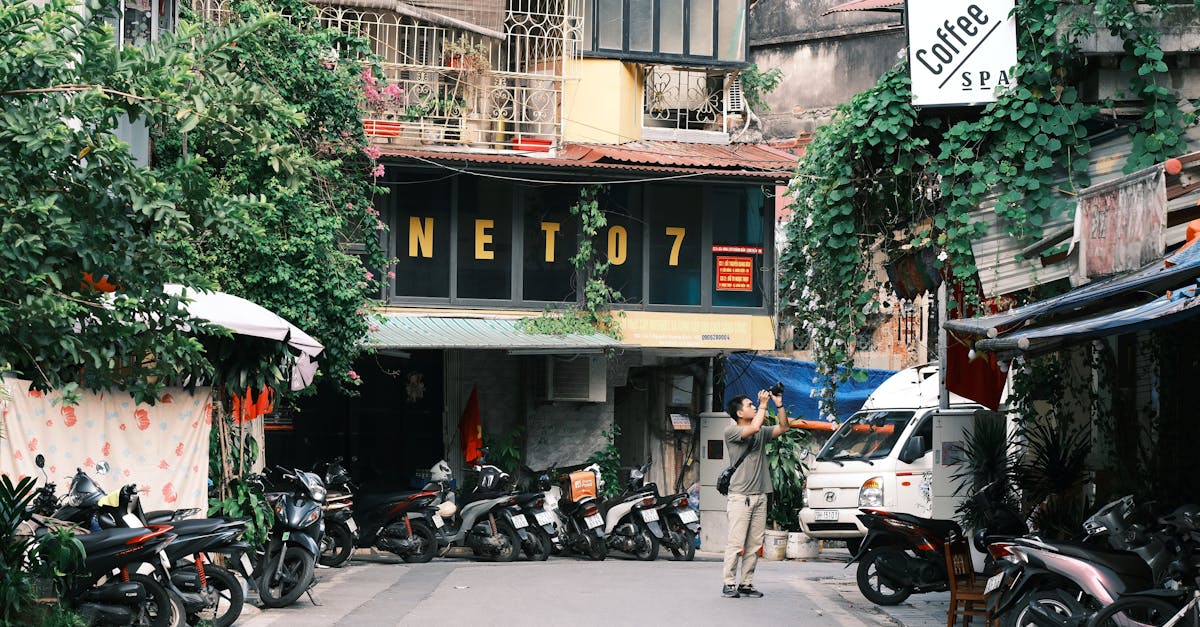 Urban alley with motorbikes and a photographer taking pictures.