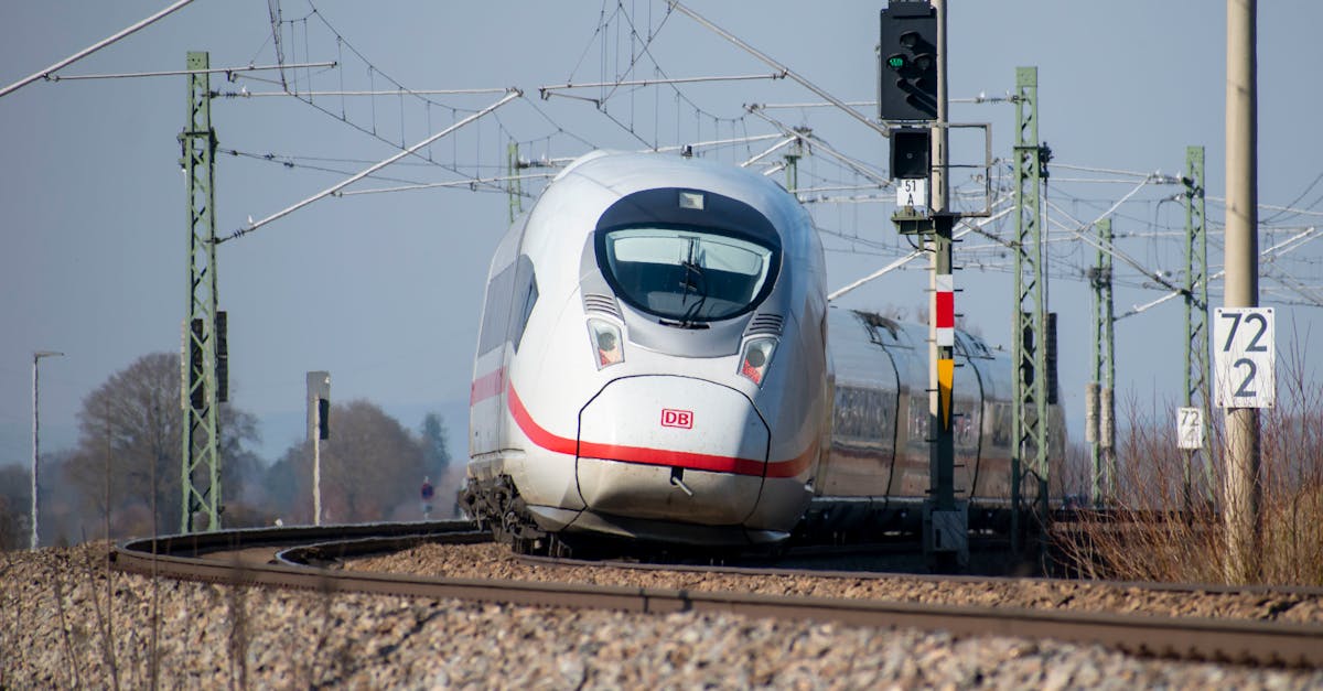 German ICE train navigating a curved track on a clear day.
