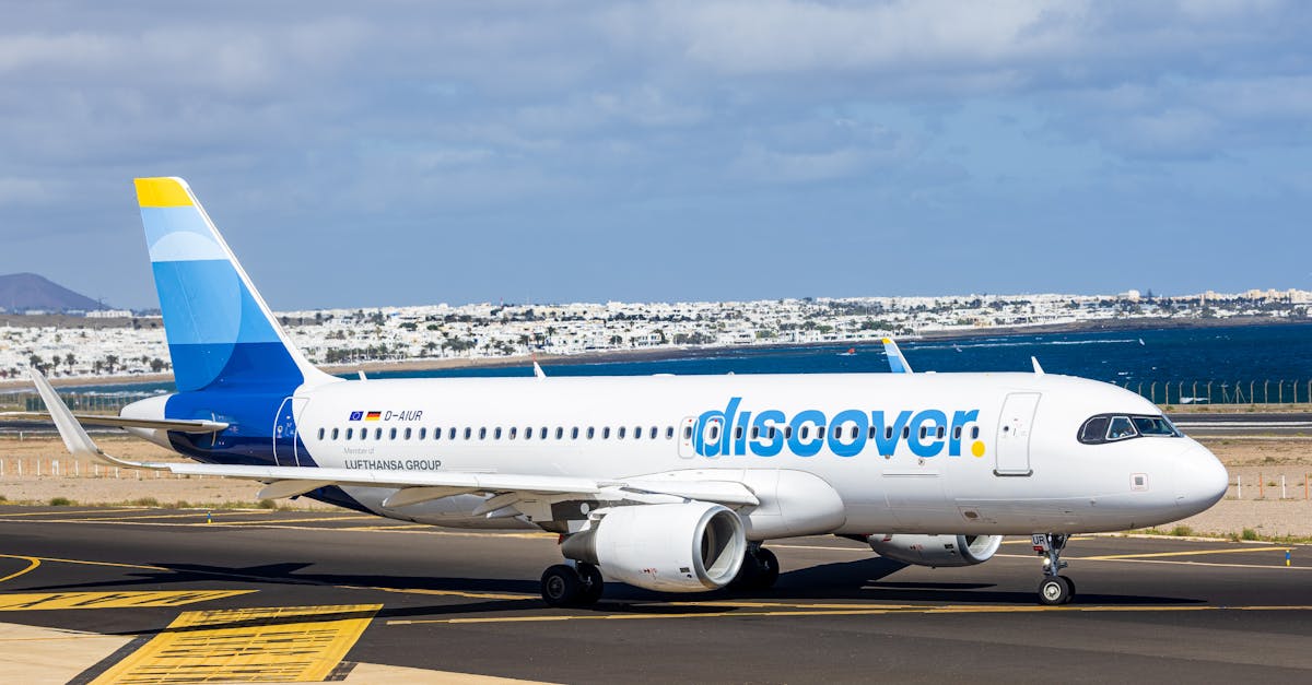 Airplane on a sunny day at Lanzarote airport, Spain, with clear skies.