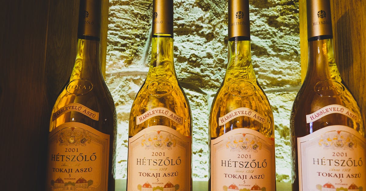 Four bottles of 2001 Hetszolo Tokaji Aszu wine in a cellar display.