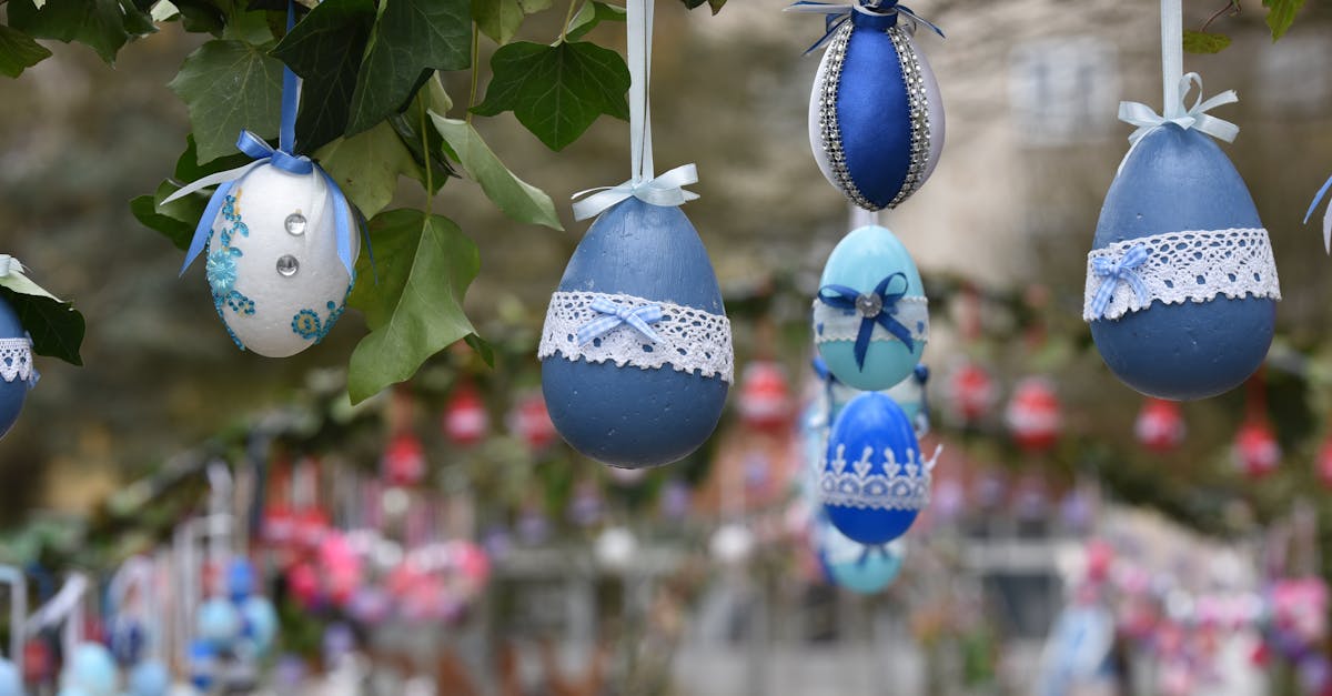 Beautifully decorated Easter eggs hanging on a branch, creating a festive outdoor display.