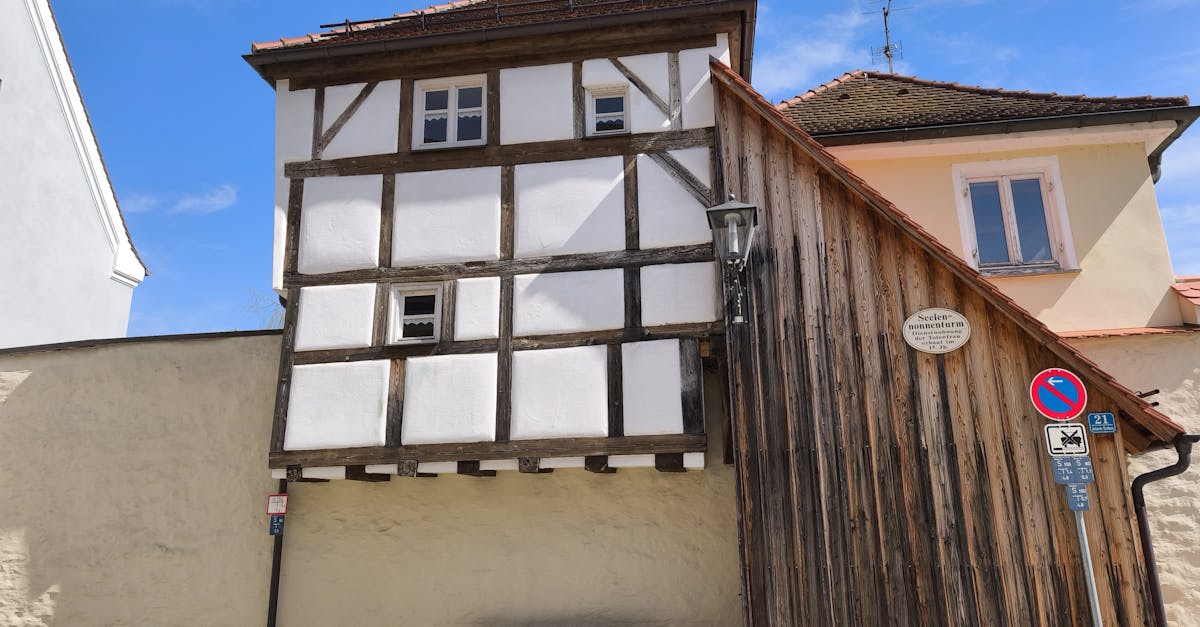 Front view of a historic half-timbered house under a clear blue sky.