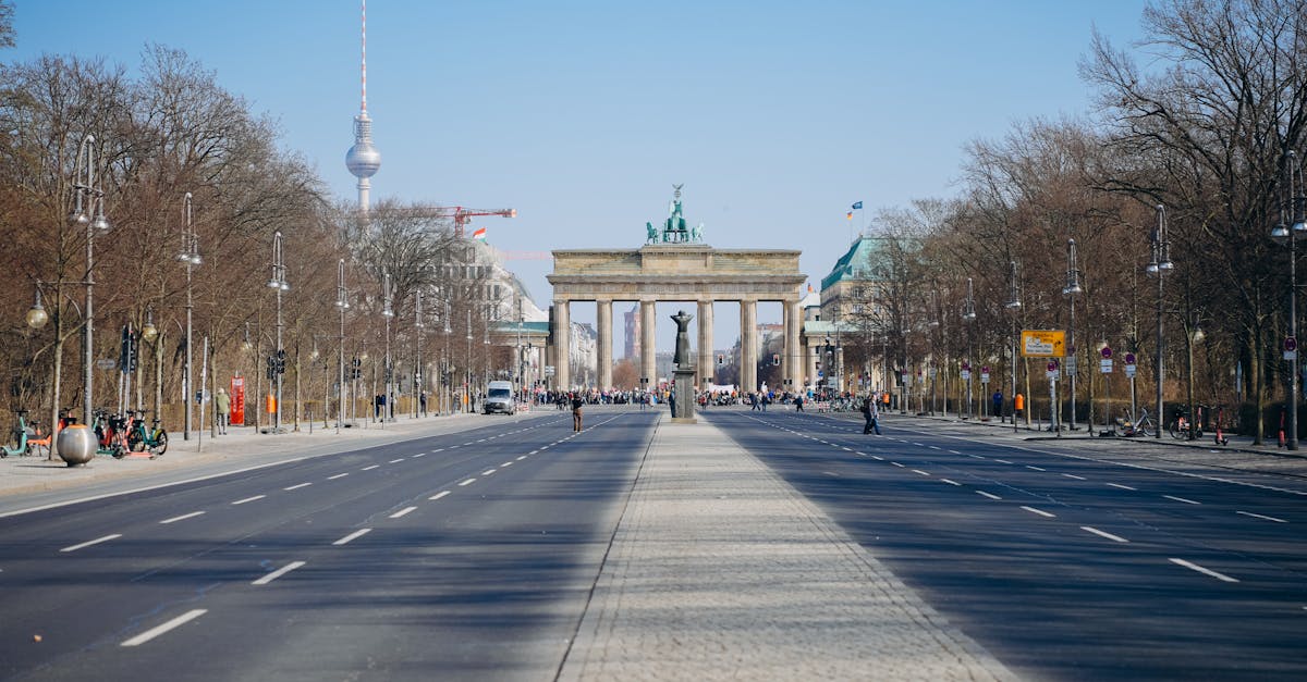 Wide view of Berlin's Brandenburg Gate and TV Tower on a clear day.