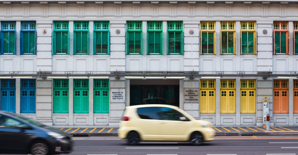 Vibrant, colorful windows on a historic Singaporean building facade.