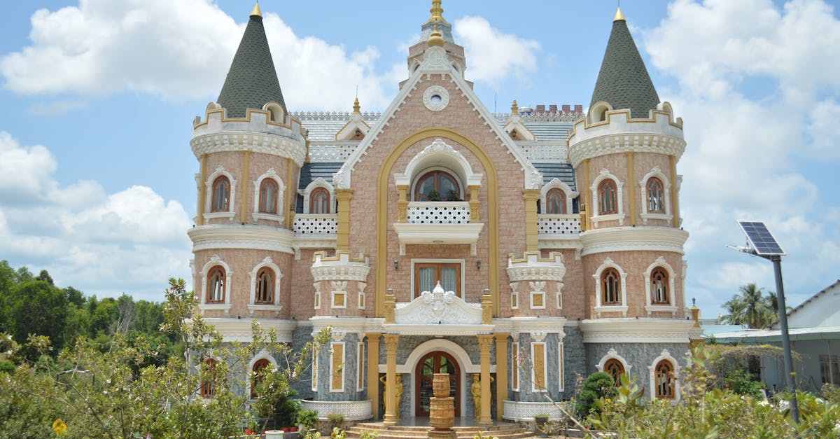 A picturesque fairy tale castle with towers set against a bright blue sky amidst lush green gardens.