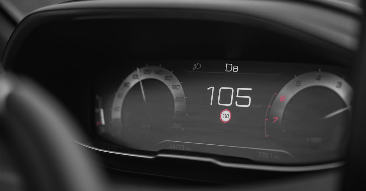 Close-up view of a digital car speedometer showing a speed of 105 in a modern vehicle dashboard.