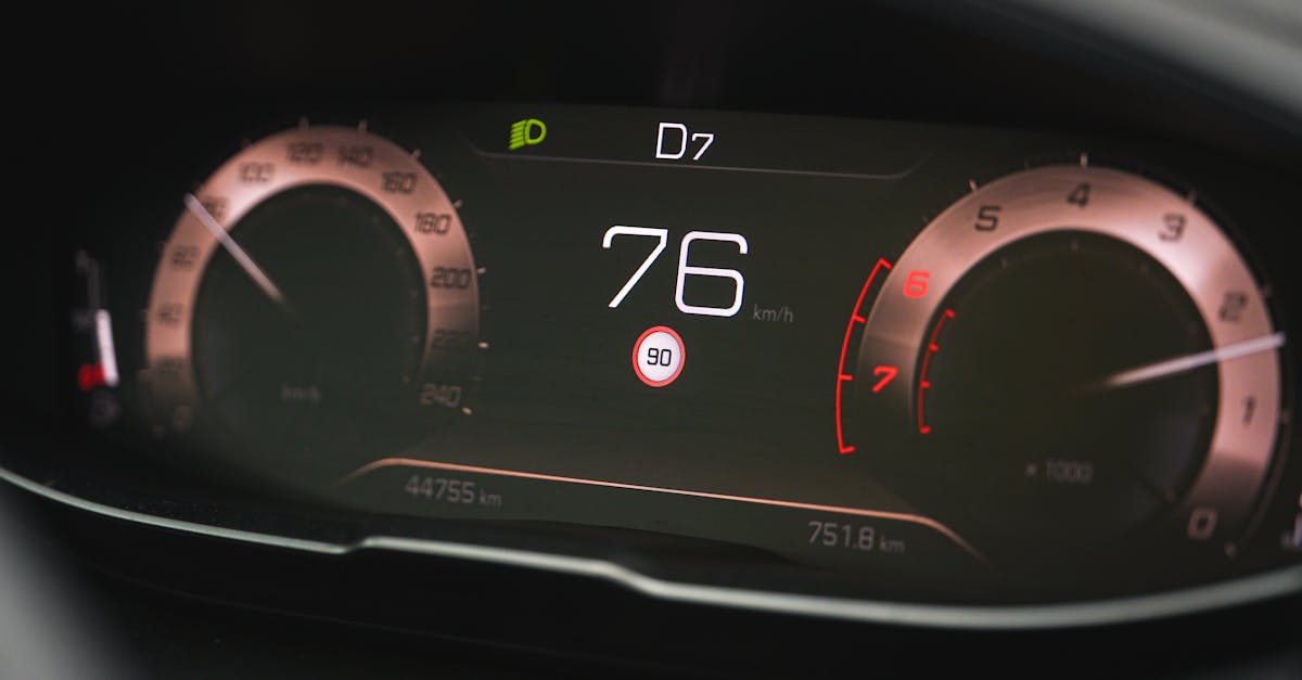Close-up of a car speedometer display reading 76 km/h with a digital dashboard interface.