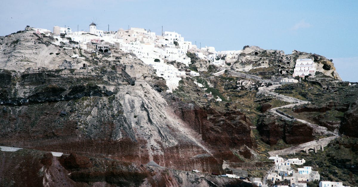 Stunning Santorini cliffside with traditional white buildings overlooking the Aegean Sea.