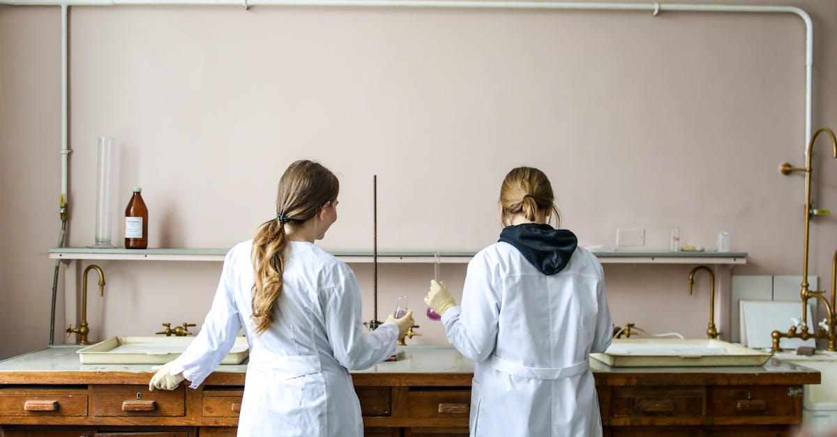 Two female scientists working on an experiment in a laboratory setting.