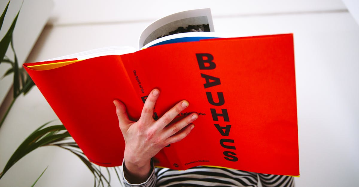 A woman engrossed in a Bauhaus book, showcasing art and design interest.