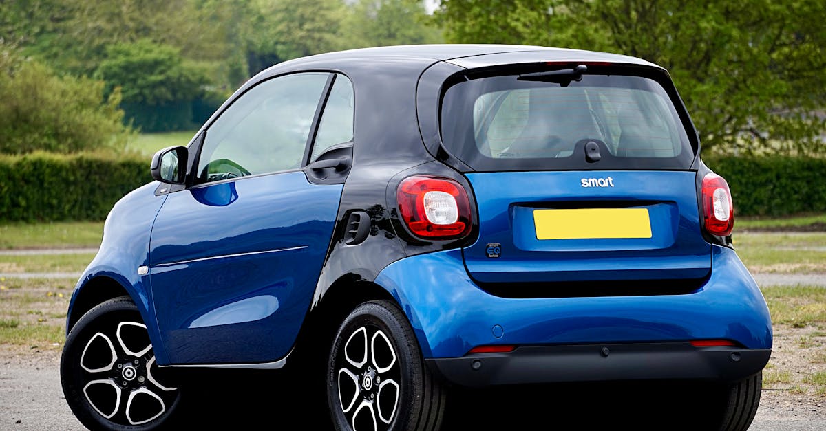 A sleek blue electric smart car parked outdoors, showcasing modern automotive design.