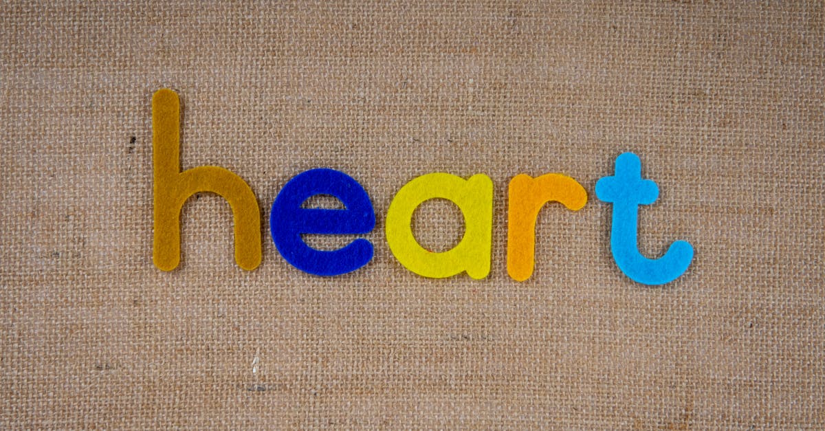 Colorful letters spelling 'heart' on a textured burlap background, perfect for creative projects.