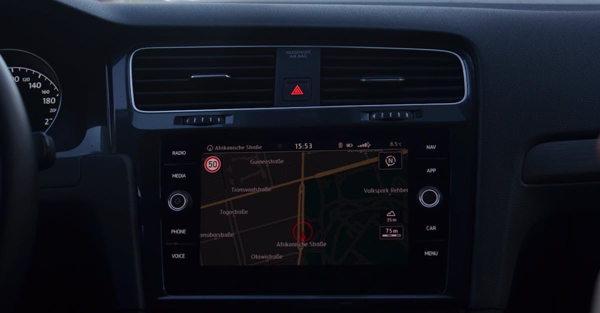 Interior of modern car with steering wheel and navigation system showing route through city streets