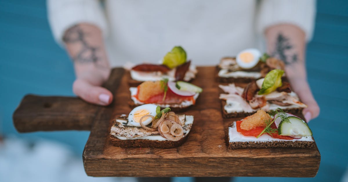 Delicious open-faced sandwiches with various toppings served on a wooden board, showcasing exquisite food styling.