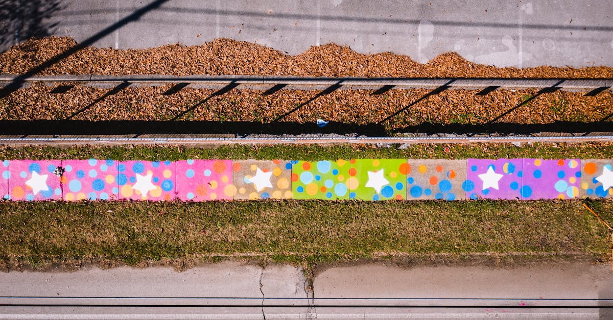 Top view of bright multicolored stars and circles drawn on wall in autumn day
