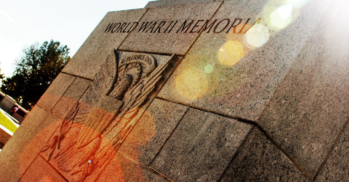 A striking view of a World War II memorial with lens flare enhancing its historic significance.