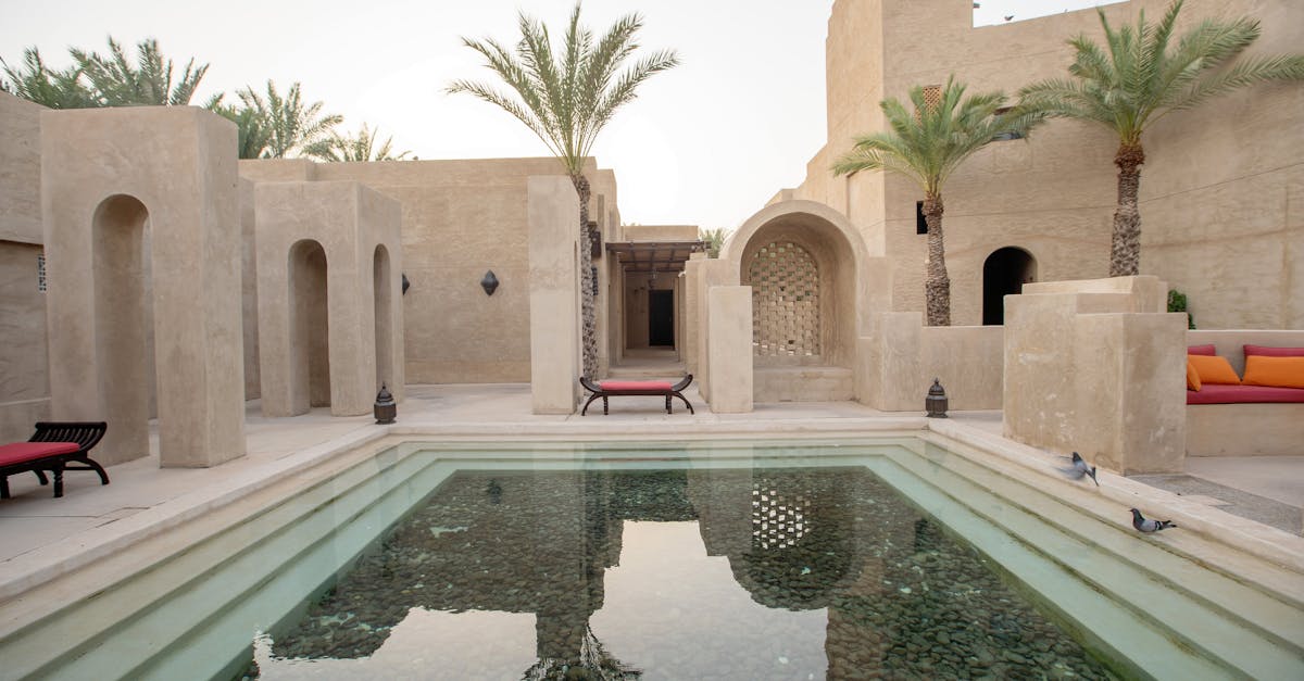 Experience serene luxury at a Dubai resort with traditional architecture and tranquil pool.
