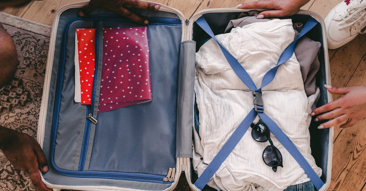 A neatly packed open suitcase with clothing and travel essentials, ready for a trip.