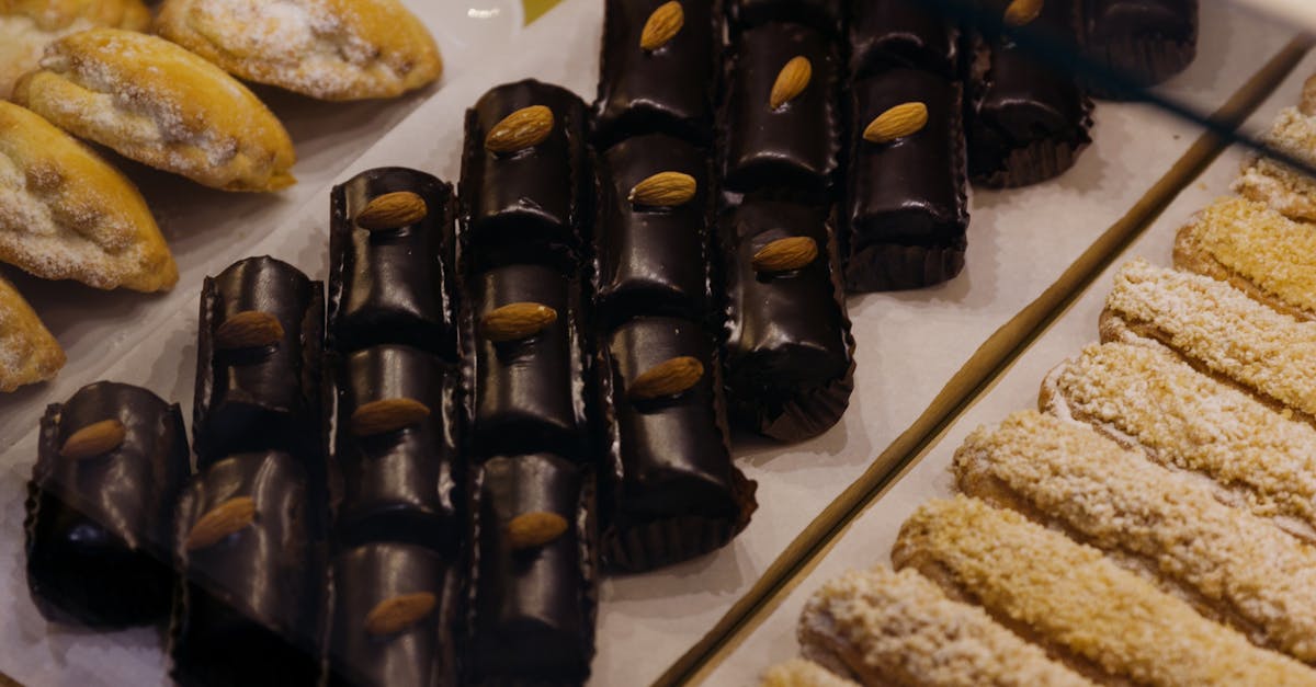 A selection of various pastries with chocolate and almonds presented in a bakery.